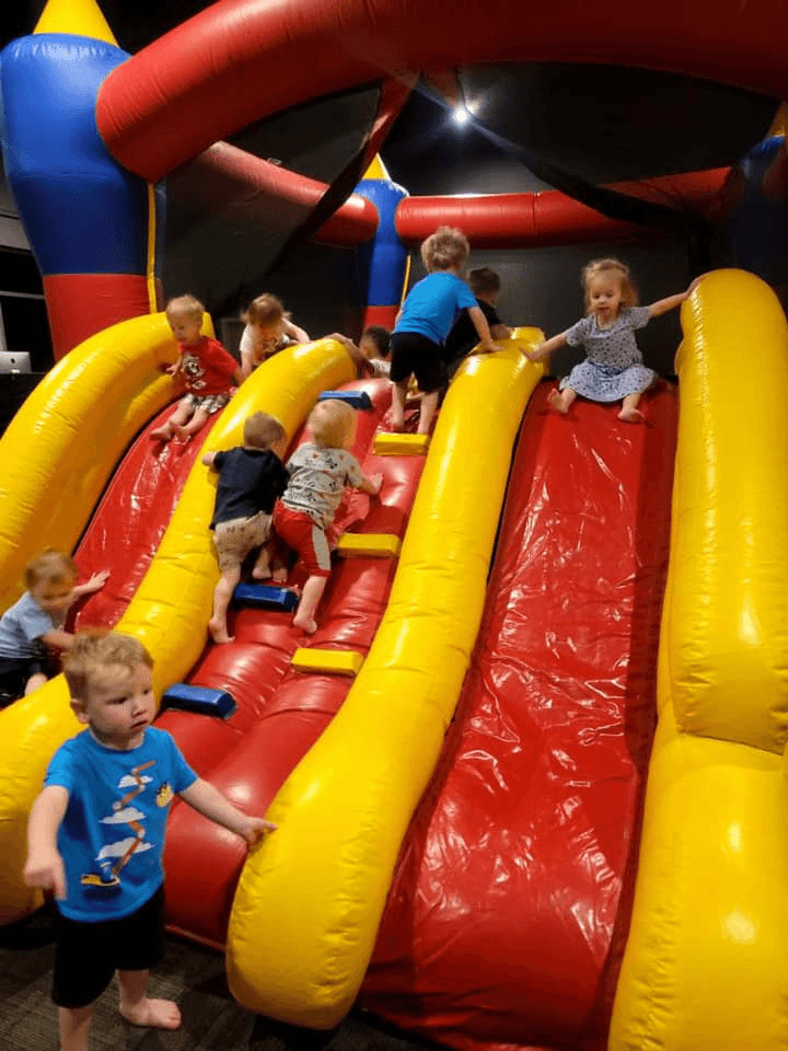 Children playing on the bounce house slide